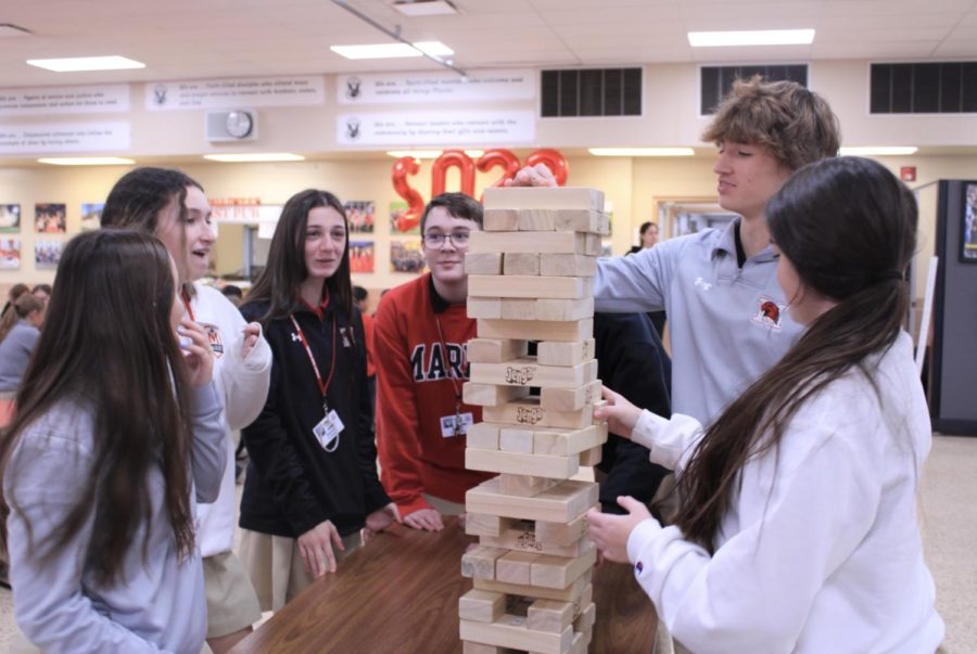 These Marist students are competing against each other in Trivia Jenga for the candy prizes.