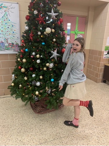 Drew Blackburn getting ready to put gifts under the tree for the annual Marist gift giving drive. 