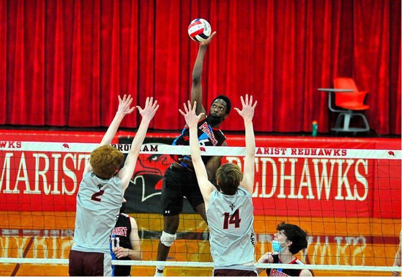 Nyherowo Omene going up for a spike while playing on the Marist volleyball team. (Photo Credit: Beverly Review)