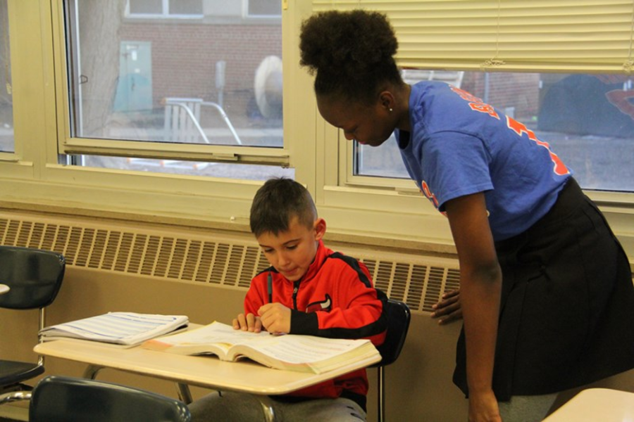 A student works with a grade school student during Marist Youth tutoring.