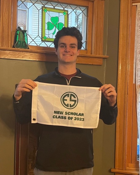 Emmett OConnor showing off this golf flag that shows his accomplishment
