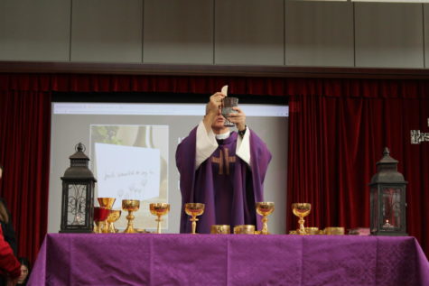 Father Tom Hurley presents the Holy Eucharist during the Lenten Mass.