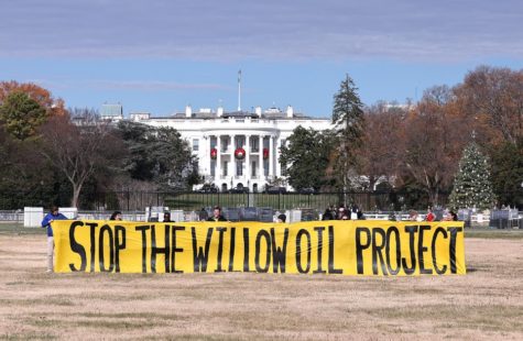 Students gathered in front of the White House with a banner to protest the Willow Project in December 2022. 