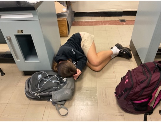 Student falls asleep in class due to exhaustion from much work.
