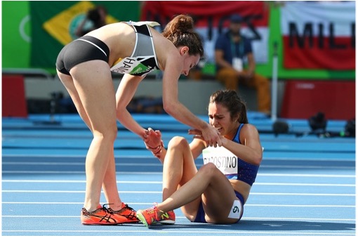 Abbey D'Agostino from the United States (on the right) receives aid from Nikki Hamblin from New Zealand after a collision on the 11th day of the 2016 Olympic Games at the Olympic Stadium in Rio de Janeiro, Brazil.