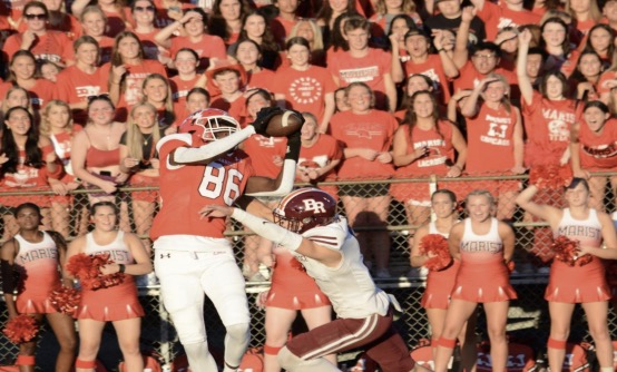 Marist sophomore Steven Brown makes the catch over a Brother Rice defender. 