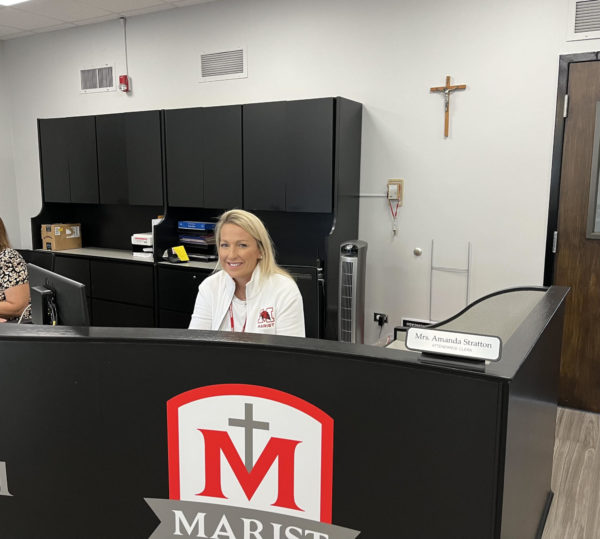 Mrs. Stratton working in the Marist High School’s main office. (Photo Cred: Hayden Krupa) 