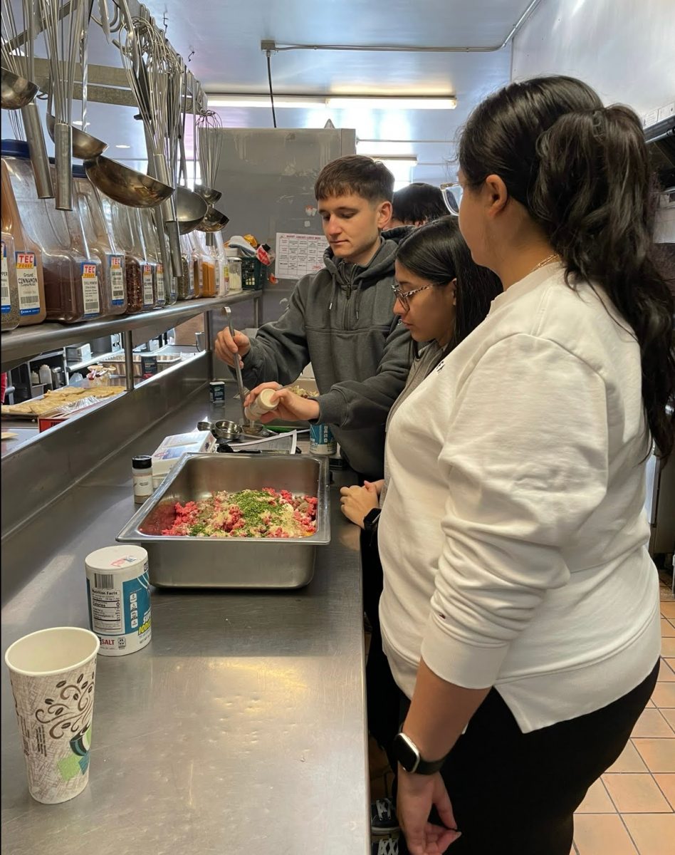 Marist students mixing ingredients to make meatballs for the homeless