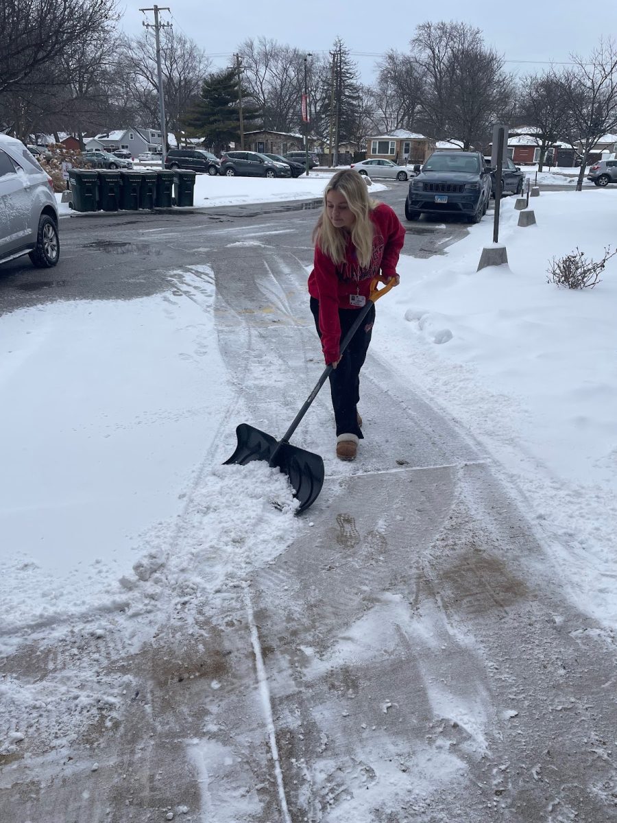Junior Drew Blackburn shoveling an entry way to help students and faculty have an easier path to use throughout the day.
