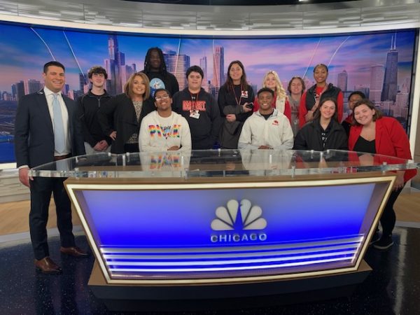 Students at the NBC5 anchor desk with News Anchor, Alex Maragos