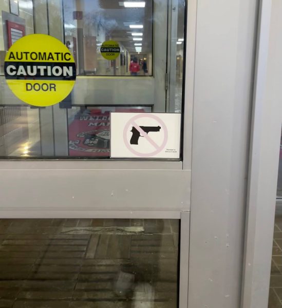 Photo of Marist High School Main Gym Entrance, showing a sign prohibiting firearms