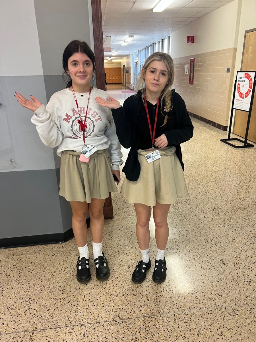 Freshmen Emily Bulvan and Molly Stipanov show an example of a rolled skirt