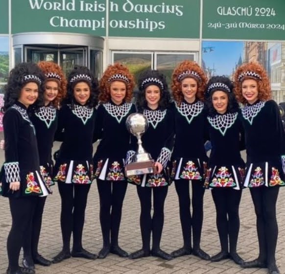Marist Irish Dancers holding the World Irish Dancing Championship Trophy (Credit: Marist Chicago on Instagram)
