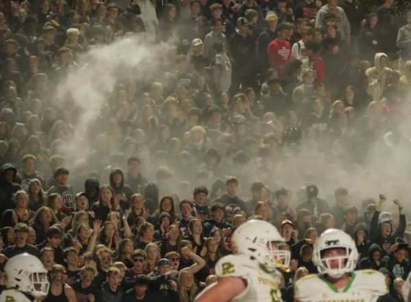 Student section during "blackout" homecoming game against Providence High School (Credit: Marist football Instagram @redhawkfb) 
