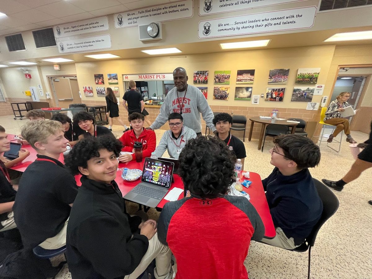 Underclassmen without their phones and Coach Topps during sixth period lunch