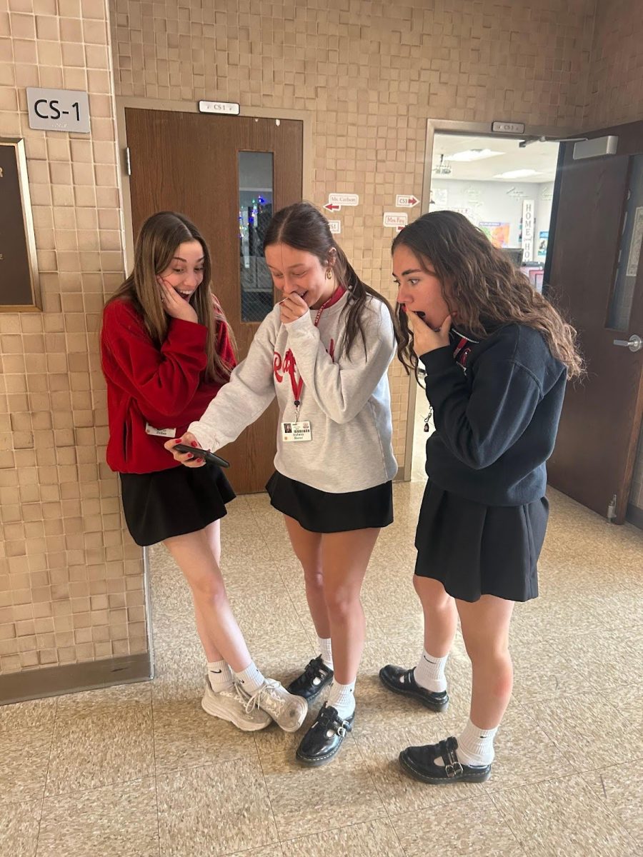 Marist students Molly Julian, Aubrey Rowe and Ava Krueger reacting to a social media post