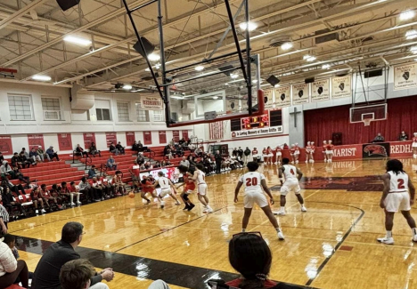 Marist junior Rokas Zilys guarding Thornton Fractional guard in their game December 2nd. (State-winning cheer team cheered the boys on during their 72-29 win)