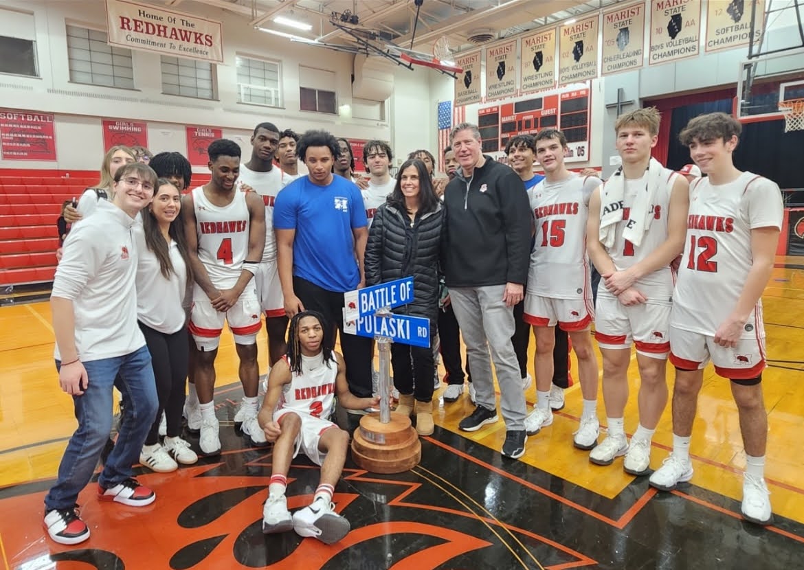 The Marist Boys Basketball Team with Principal Meg Dunneback, President Larry  Tucker, and team managers with the Battle of Pulaski trophy (Credit: George Kottaras)