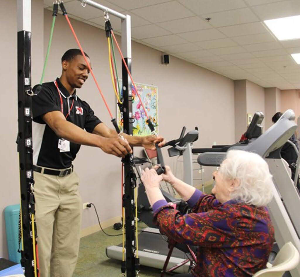 A Marist student participating in senior service by helping an elderly patient (Credit: Marist.net)