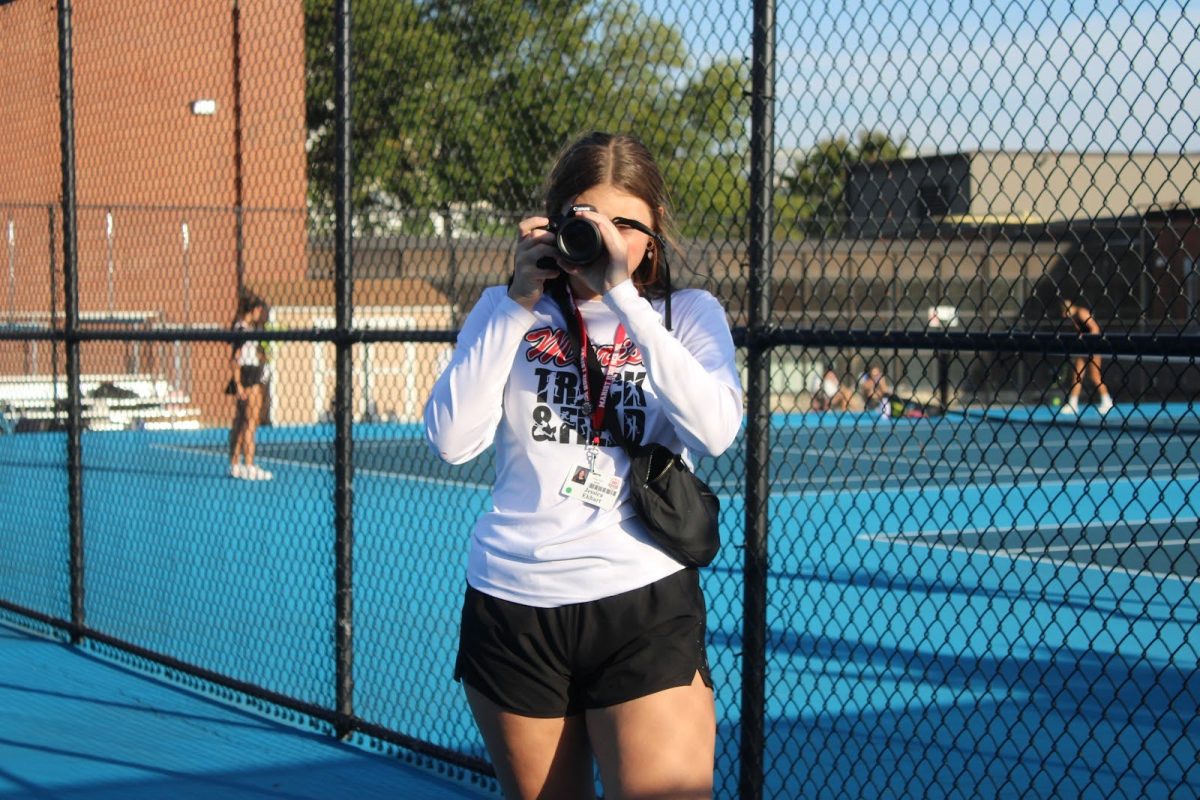 Jessica Ekhart, Chief Editor of  Yearbook Club, taking a picture