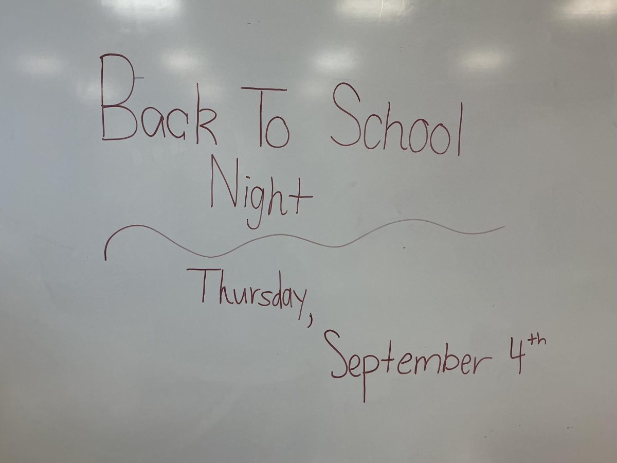 A classroom whiteboard displaying the date of Back to School Night