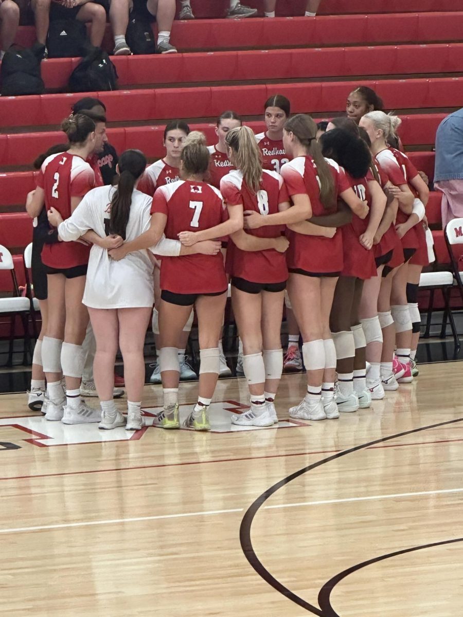RedHawks mid-huddle during an ESCC matchup against the Nazareth Roadrunners