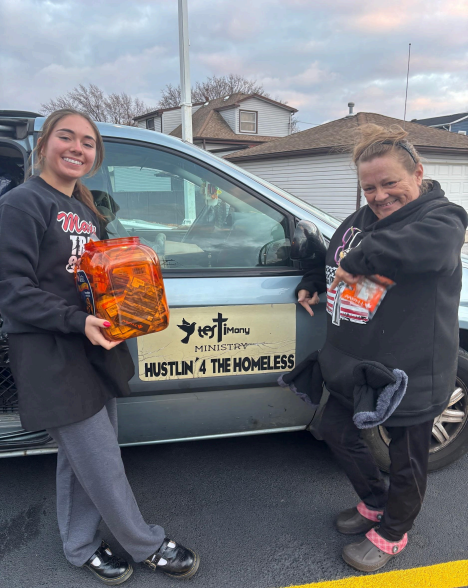Ava Krueger and Tanya Sparks-Guenzler packing a car with warm clothes and hand warmers as the winter months begin