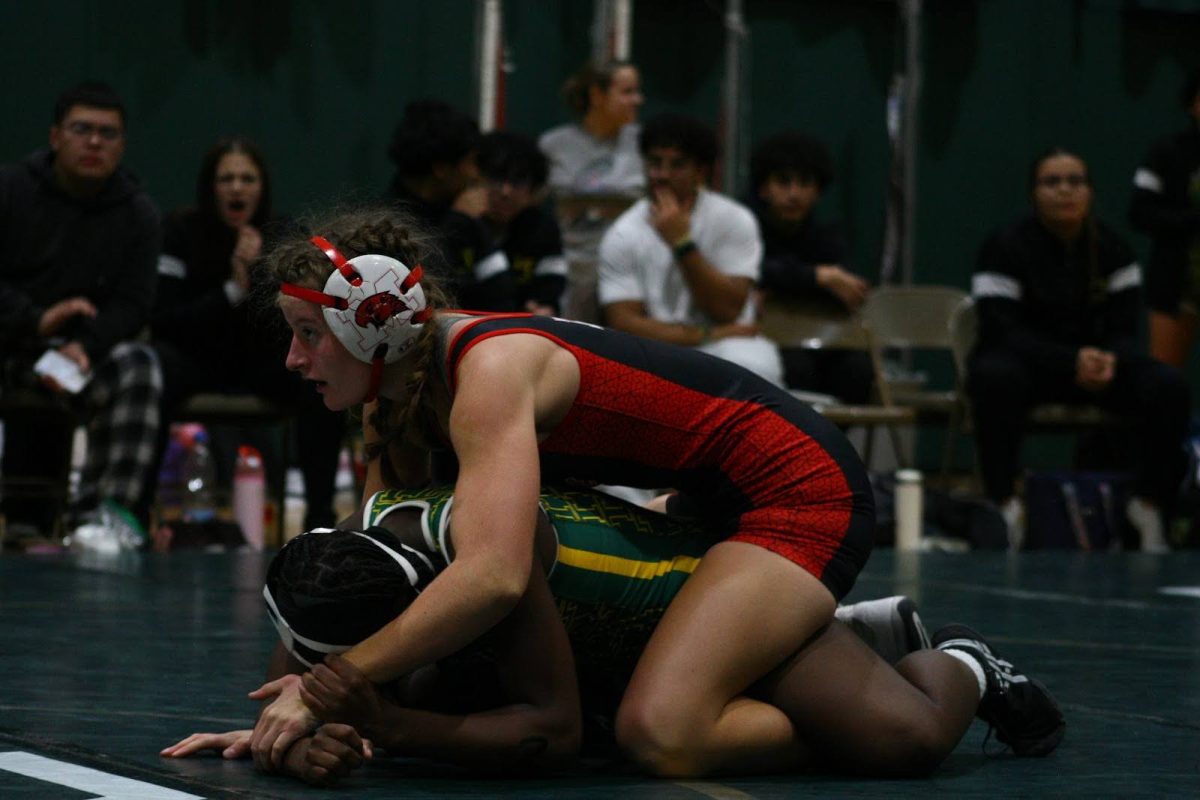 Senior Stella Harris in action, wrestling at the 130 weight class