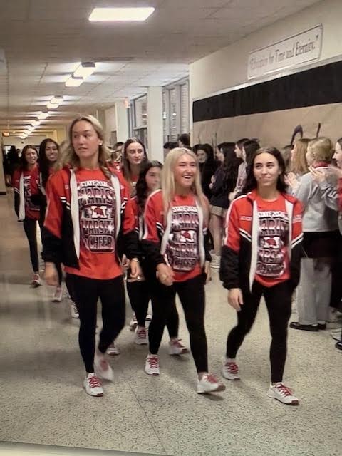 Students applaud the Marist cheer team as they head to state competition