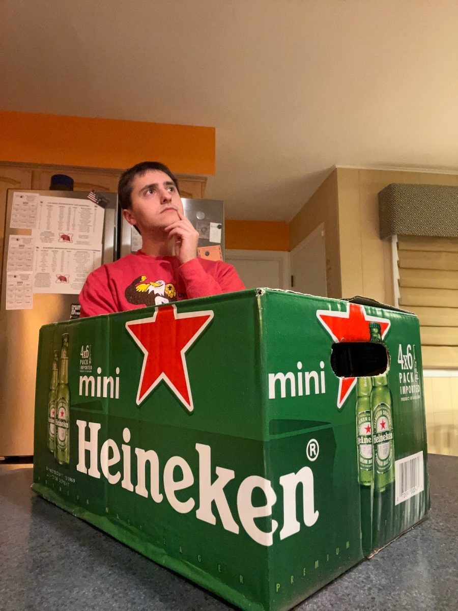 Senior George Kottaras ponders nearby a case of alcohol