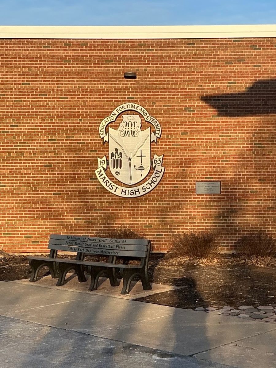 A plaque outside Marist High School displaying its mission
