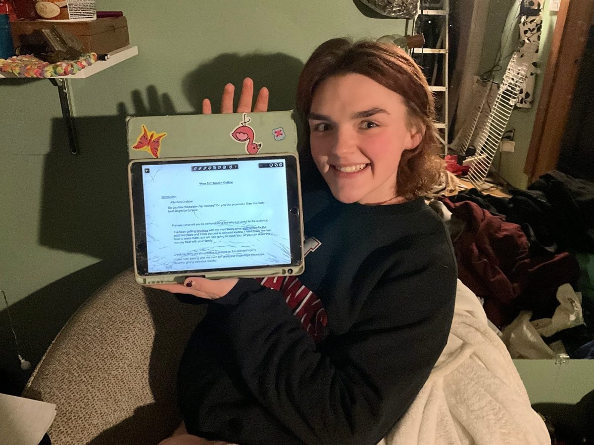 Senior Sarah Parker with her “How to” speech document from freshman year speech class