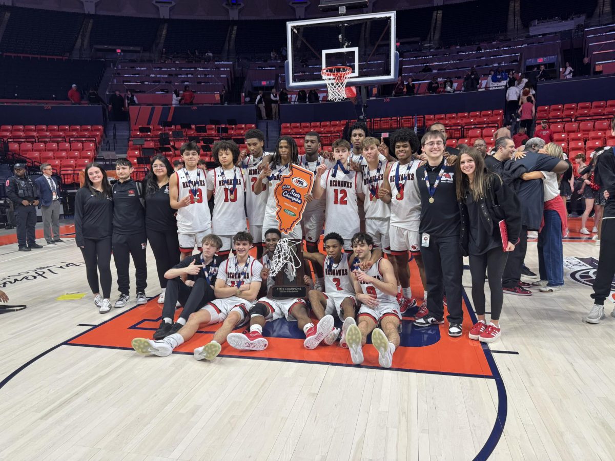 The boys varsity team with their coaches and managers after winning the state championship Saturday, March 14