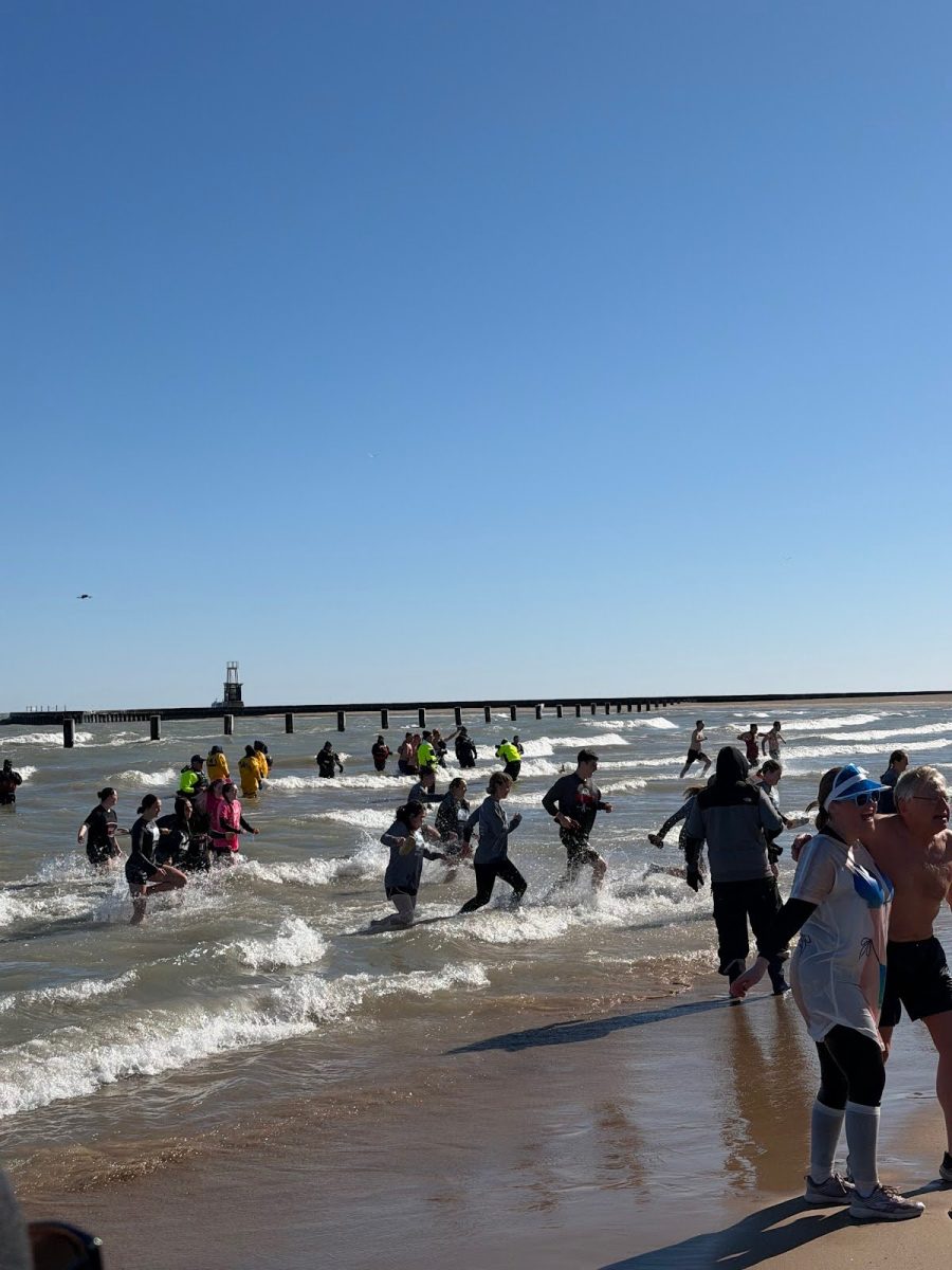 Marist students rushing out of the water after braving the annual Polar Plunge