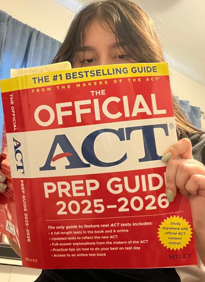 A Marist student looking through an official ACT prep book