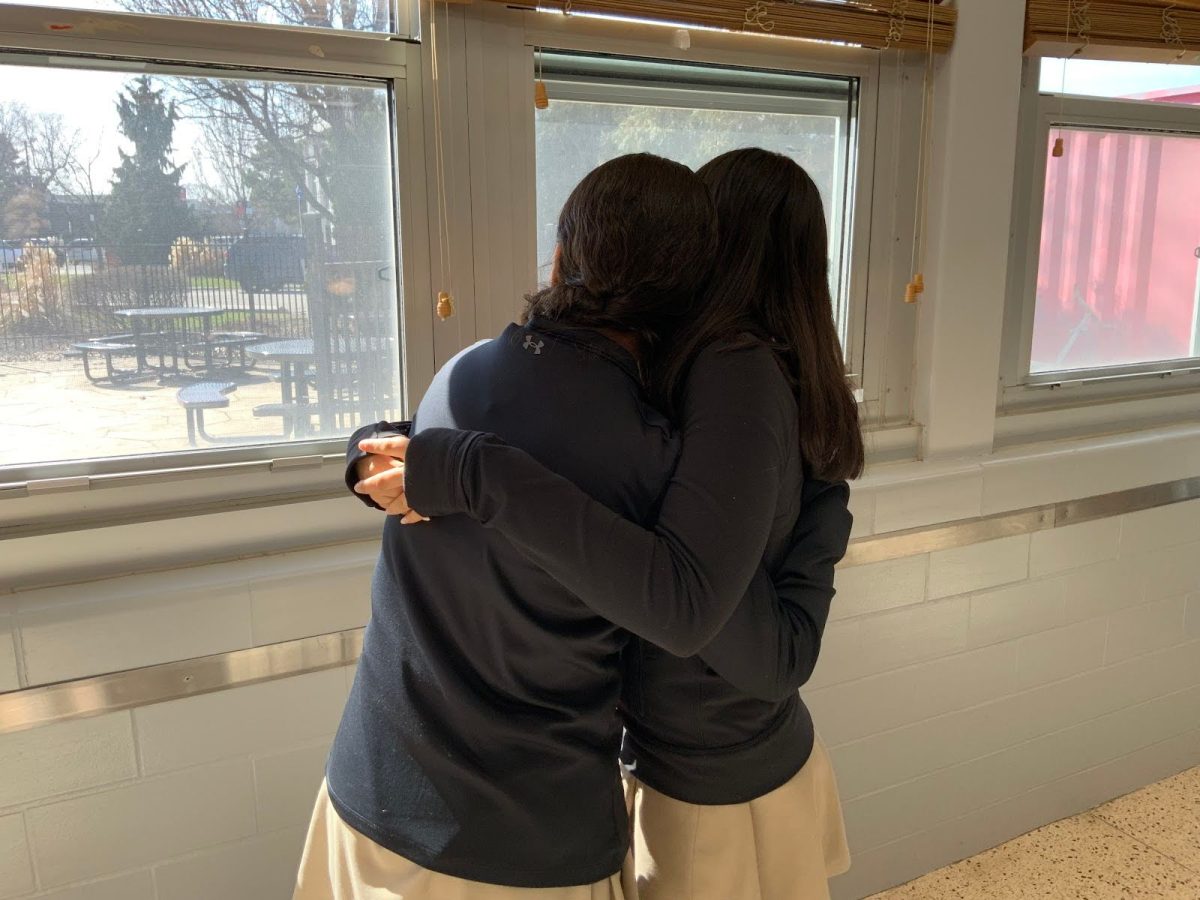 Freshmen Breana Cartagena and Gianna Martinez embracing