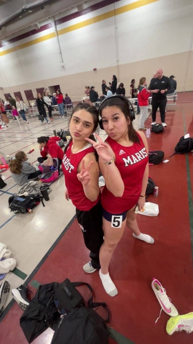 Nicole Vasquez with her freshman sister before a track meet at Lockport High School